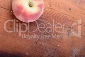 Peach on wooden plate