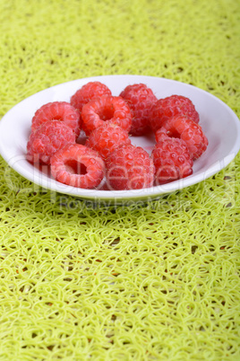 fresh raspberries on the white plate