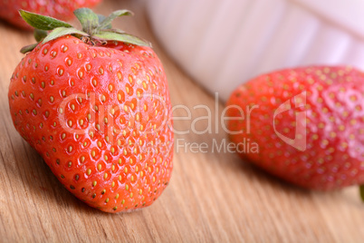 Strawberry set on wooden plate close up