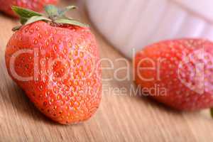 Strawberry set on wooden plate close up