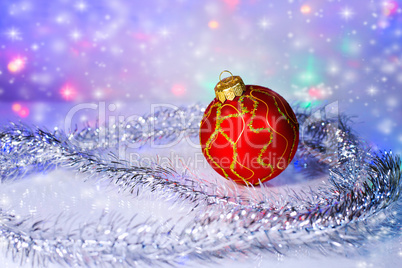Red Christmas-tree ball and tinsel. Christmas decorations.