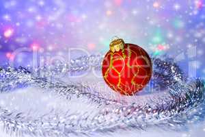 Red Christmas-tree ball and tinsel. Christmas decorations.