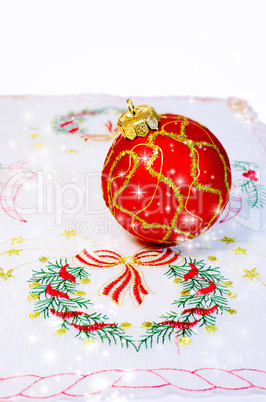 Red Christmas ball embroidered napkin isolated. Christmas decora