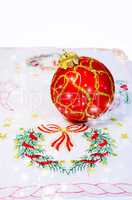 Red Christmas ball embroidered napkin isolated. Christmas decora