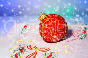 Red Christmas ball on a napkin. Christmas decorations.