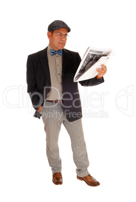 Man standing and reading the newspaper.