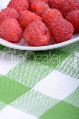 fresh raspberries on the white plate