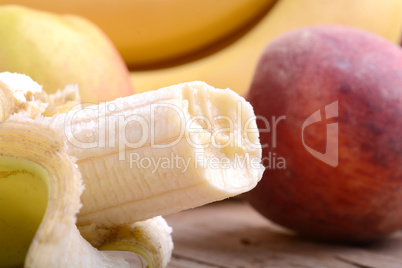 fruits on table, apple, bananas, peach close up, health food concept