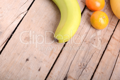 Fresh colorful fruits composition mandarin, bananas and orange