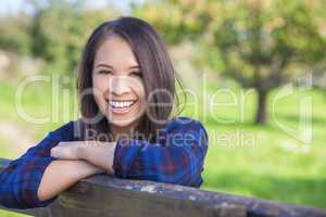 Beautiful Asian Eurasian Girl Resting on Fence