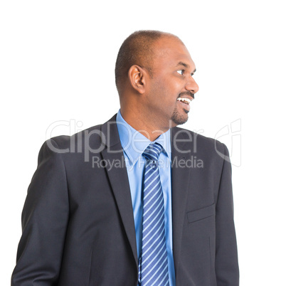 Indian businessman smiling and looking to side