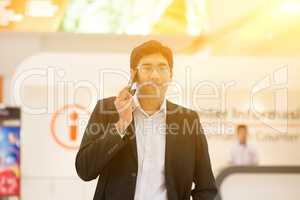 Indian businessman walking by information counter