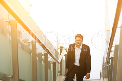 Indian businessman ascending steps.