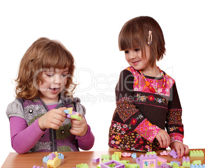 little girls play with toy blocks