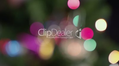 Defocused Christmas tree with star, ball and snowflake