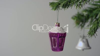 Purple Christmas toy and silver bell on the Christmas tree branch