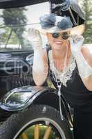 Woman in Twenties Outfit Near Antique Automobile