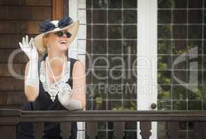 Attractive Woman in Twenties Outfit on Porch of Antique House