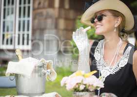 Twenties Dressed Woman Eating and Drinking Champagne At Outdoor
