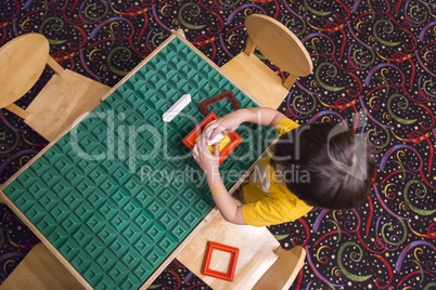 Overhead of Boy Playing With His Toys at Table