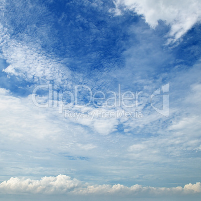 The white cumulus clouds against the blue sky