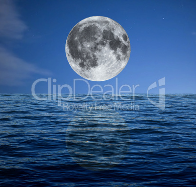 Full moon at night over the sea