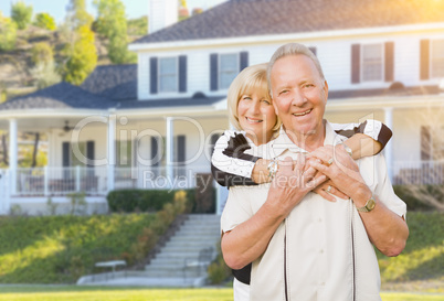 Happy Senior Couple in Front Yard of House