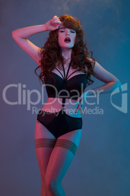 red haired woman wearing lingerie and stockings