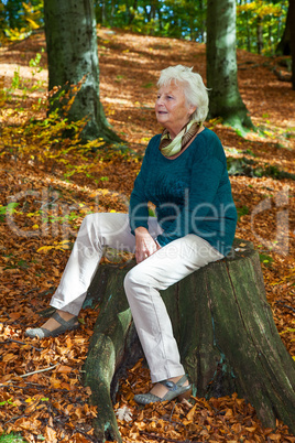 Seniorin enjoys the outdoors in autumn park