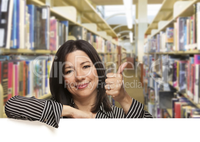 Hispanic Woman with Thumbs Up On White Board in Library