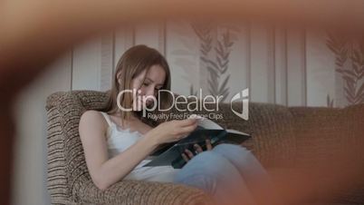 Young woman reading a book on the couch
