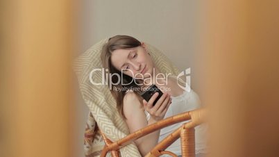 Young beautiful woman sitting with smart phone.