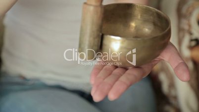 Young beautiful lady relaxing with nepal singing bowl