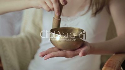 Young beautiful lady relaxing with nepal singing bowl