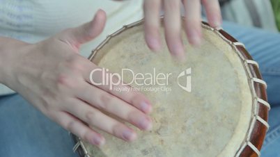 Women playing on Jambe Drum on nature