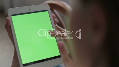 Woman hands touching and scrolling tablet.green screen display