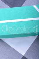 Green gift box with white ribbon