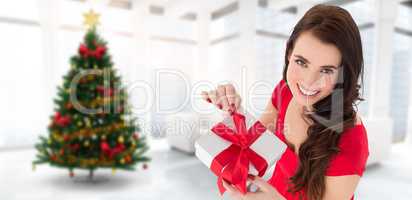 Composite image of happy brown hair opening gift