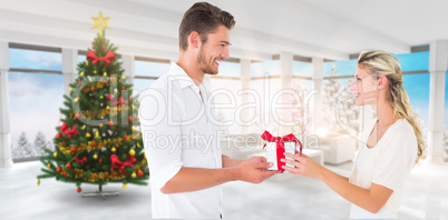 Composite image of young couple with gift