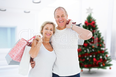 Composite image of couple with shopping bags