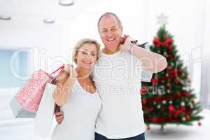 Composite image of couple with shopping bags