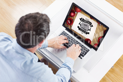 Composite image of man using laptop