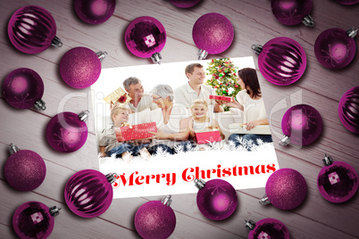 Composite image of christmas baubles on table