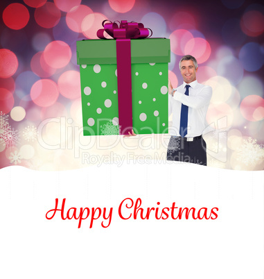 Composite image of stylish man with giant gift