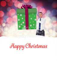 Composite image of stylish man with giant gift