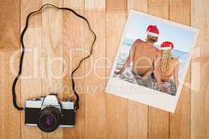 Composite image of rear view of couple sitting on beach