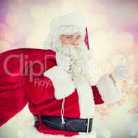 Composite image of positive santa with his sack and thumbs up