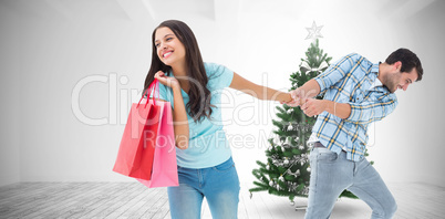 Composite image of happy couple with shopping bag