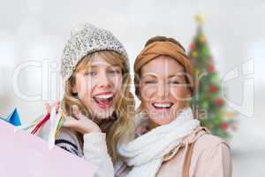 Composite image of smiling women looking at camera with shopping