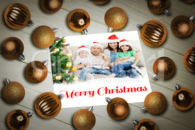 Composite image of christmas baubles on table